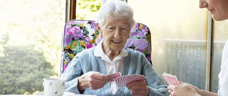 Older woman plays card