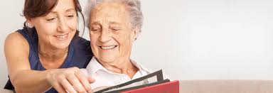 Companion looks at photographs with older woman